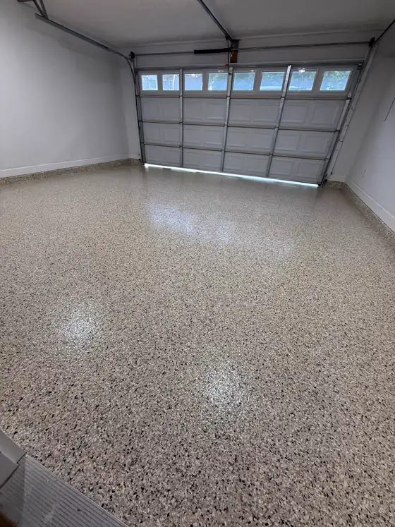 Grey flake garage floor seen with the garage door open