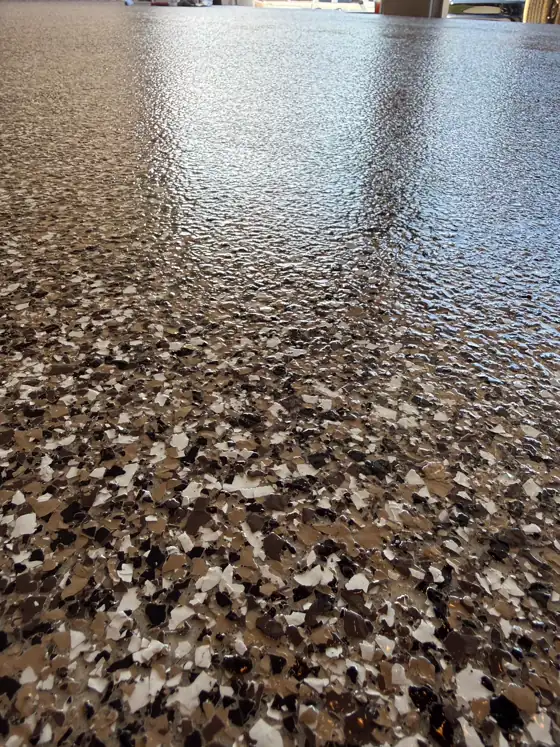 Brown and tan flake floor in an open garage bay