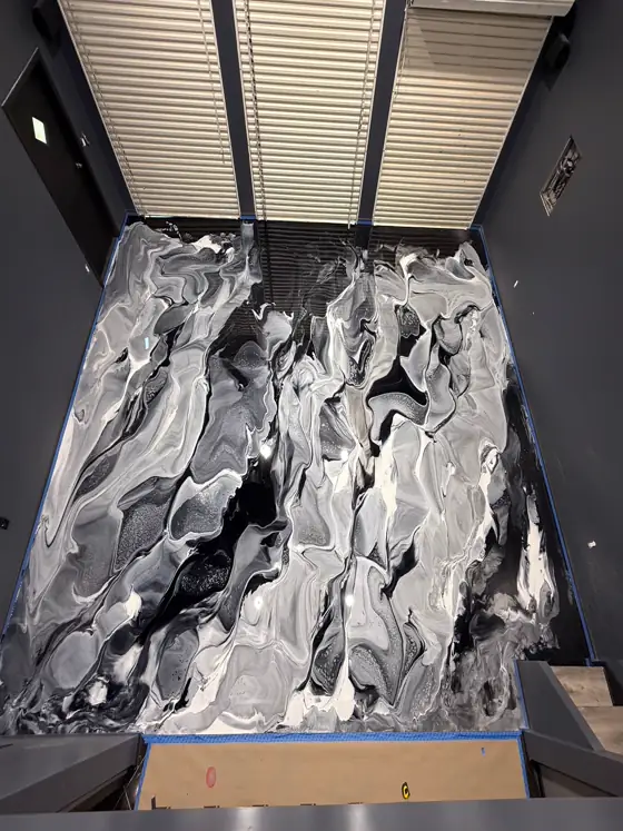 Black, white and silver marbled metallic floor filling a garage bay