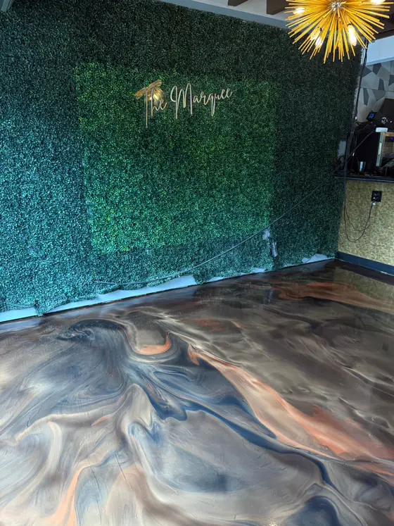 Copper and navy metallic floor against a green moss wall