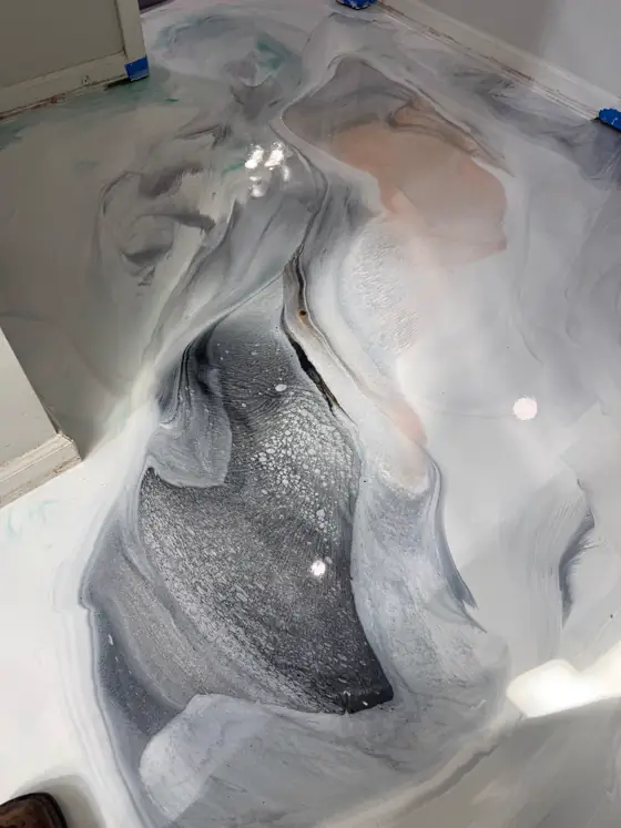 Silver and charcoal movement through a white metallic floor