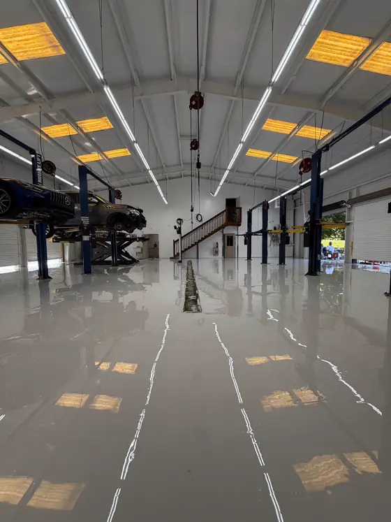 Full-length white epoxy shop floor with a high gloss